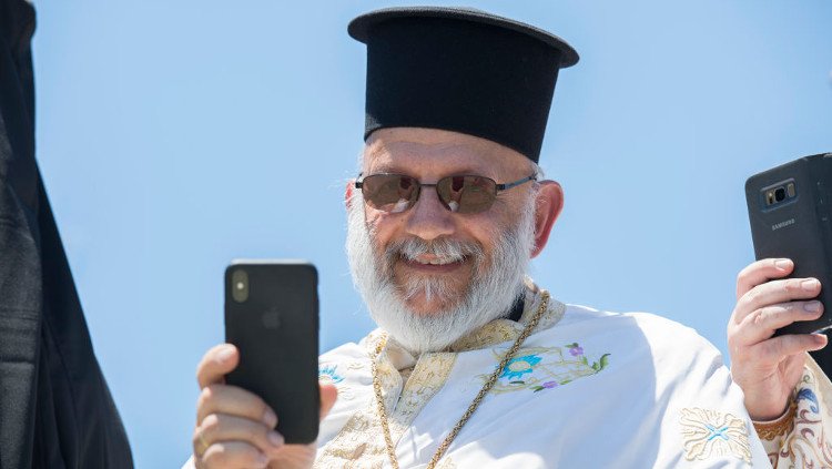 Greek priest with iPhone