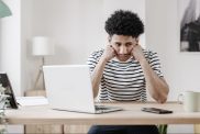 young man with laptop unhappy at work how to survive a job you hate