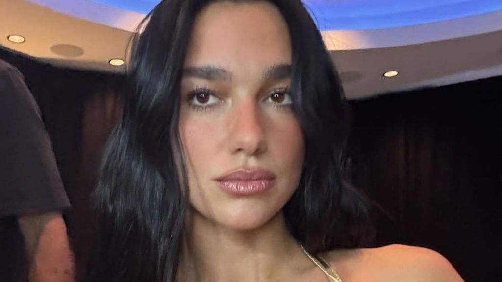 Dua Lipa Drips in Gold With a Bold All-Black Fit in YSL Beauty Photos