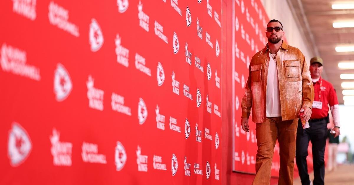 Travis Kelce Channels Showgirl in Orange Outfit Ahead of Chiefs Game
