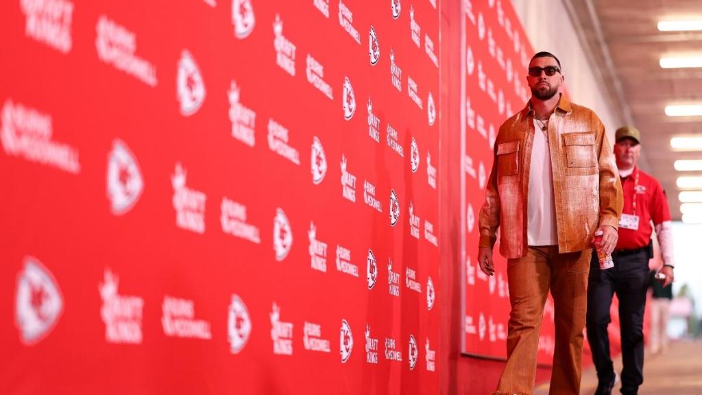 Travis Kelce Channels Showgirl in Orange Outfit Ahead of Chiefs Game