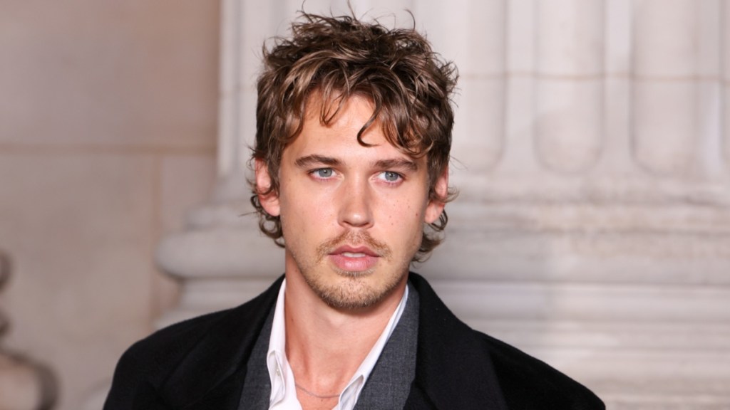Austin Butler Wears Black Overcoat at YSL Fashion Show
