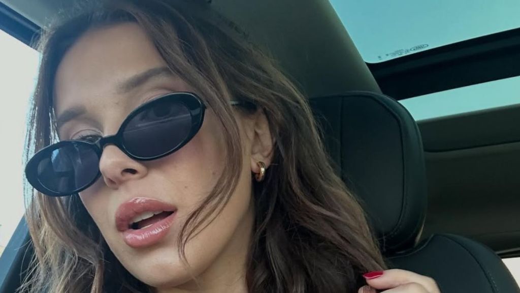 Millie Bobby Brown Shows off Lip Gloss in Her Cami Top Video