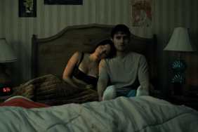 A girl leans up against a guy in Obsession.