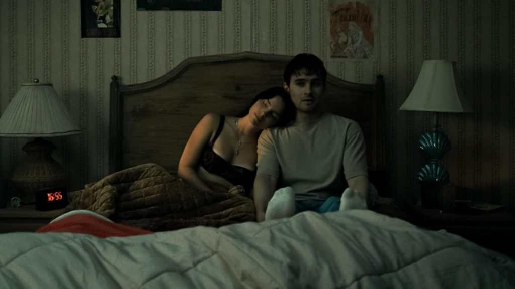 A girl leans up against a guy in Obsession.