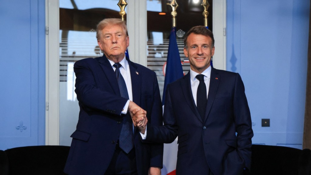 Donald Trump & Emmanuel Macron's Handshake Is Raising Eyebrows