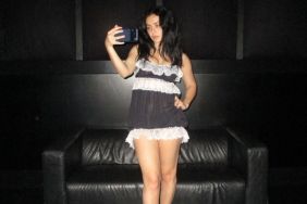 Charli XCX Ditches Her Clothes & Holds a Tiny T-Shirt to Barely Cover Her Curves