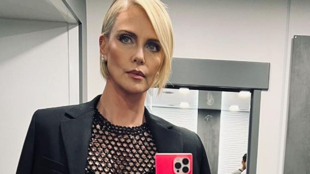 Charlize Theron Walks in Micro Shorts That Completely Hide Under Her Unbuttoned Jacket
