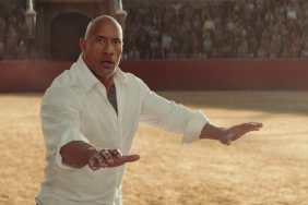 Dwayne Johnson puts his hands out in Red Notice.