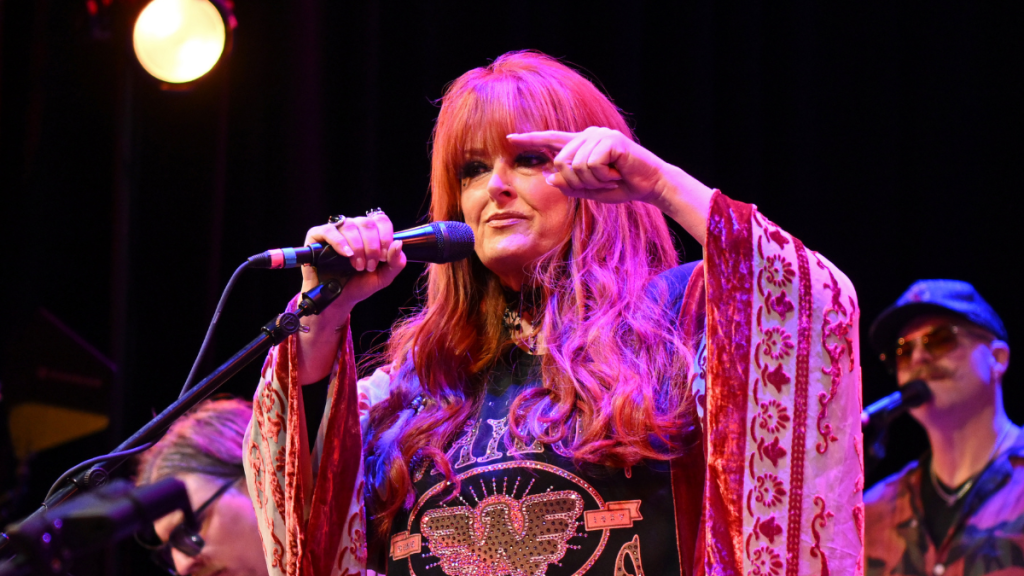 Wynonna Judd performing onstage amid the release of her personal new song “Girl Who Could Sing.”