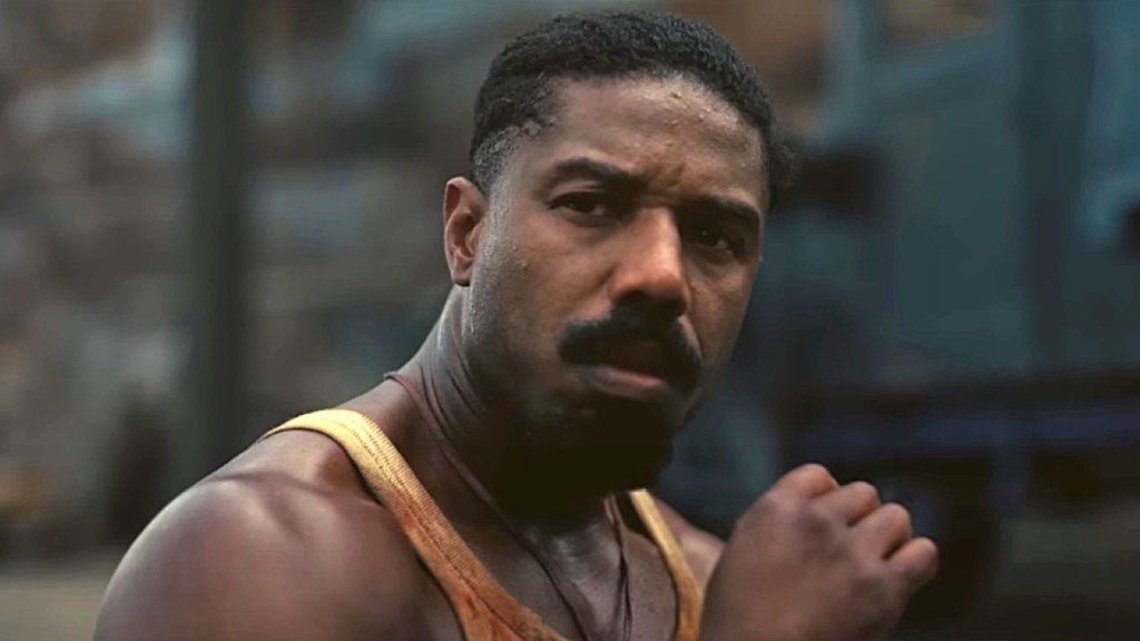 Michael B. Jordan & RAYE’s Kissing Roller Coaster Photo Sparks Dating Rumors