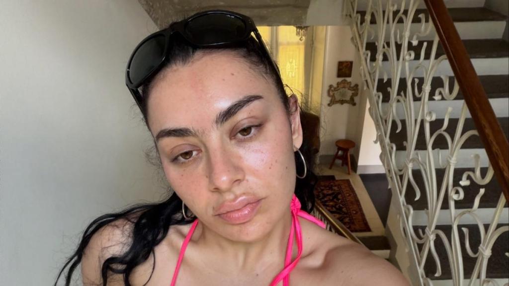 Charli XCX Poses in Bed in Nothing but a Skimpy Plunging Lace Bra