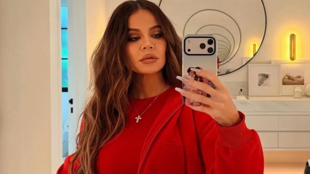 Khloe Kardashian’s Low-Cut Black Dress Doubles Down With a Waist-High Slit