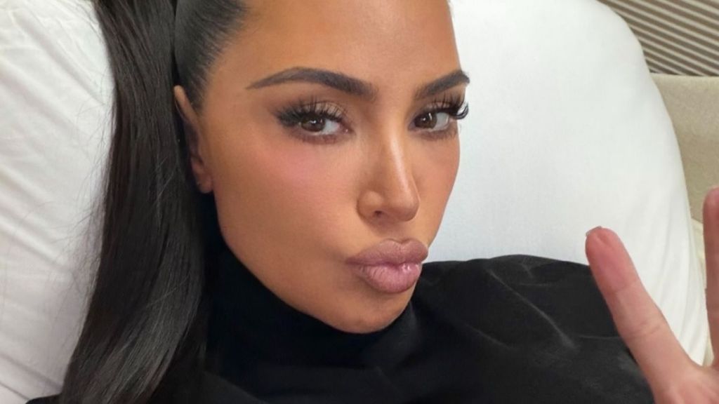 Kim Kardashian Wears Nothing but a Robe That Barely Contains Her Curves