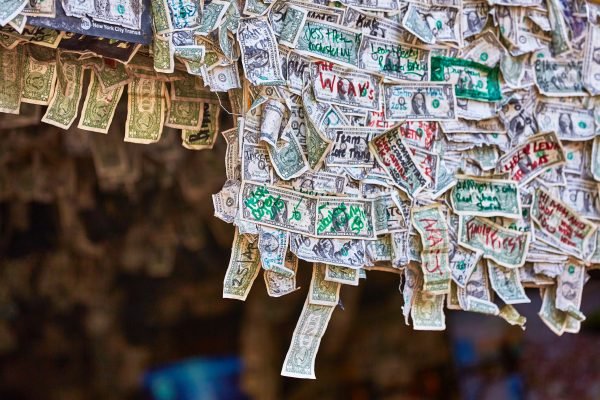Mandatory Good News: Bar Owner Donates All the Dollar Bills Stapled to Her Walls to Furloughed Employees