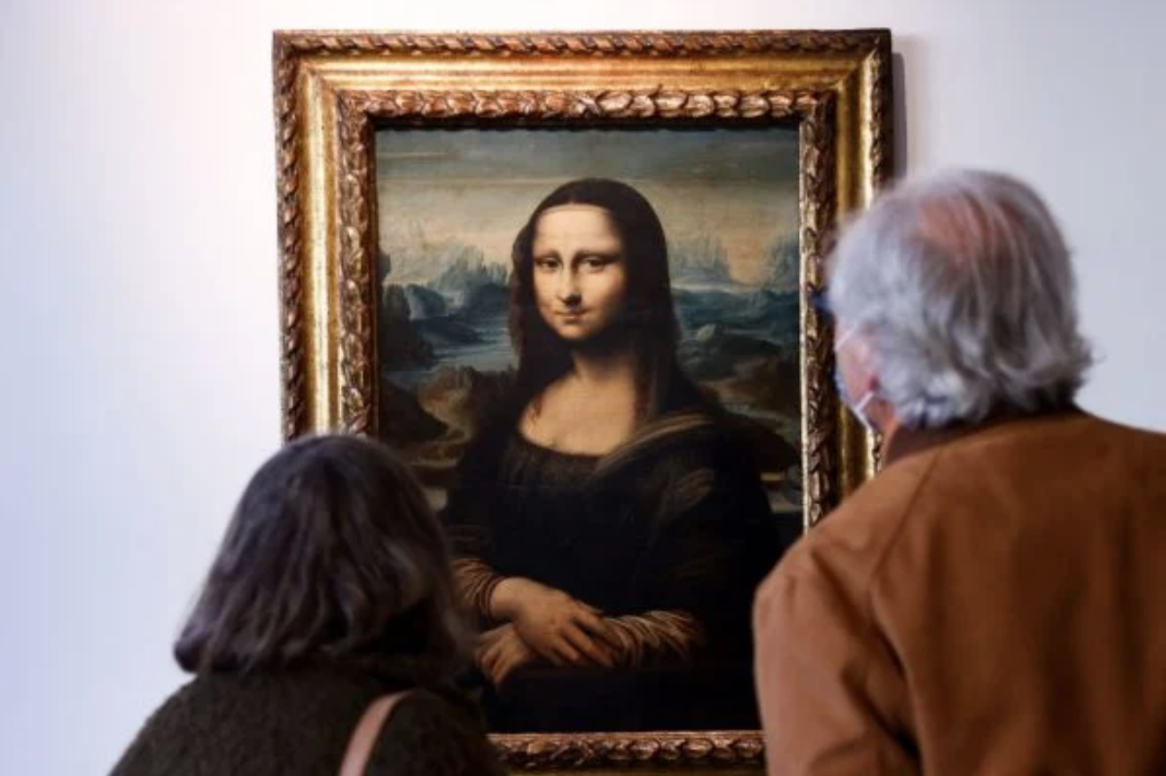 Man Disguised as Old Woman Smears Cake on the Mona Lisa (Total Waste of Cake In Our Humble Opinion)