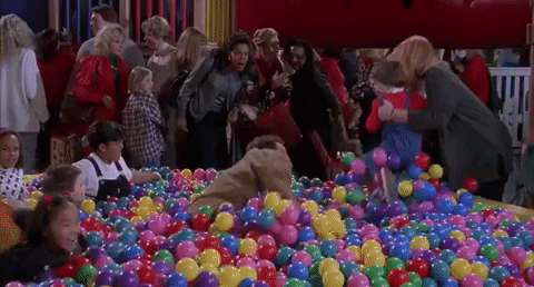Playing in the ball pit.