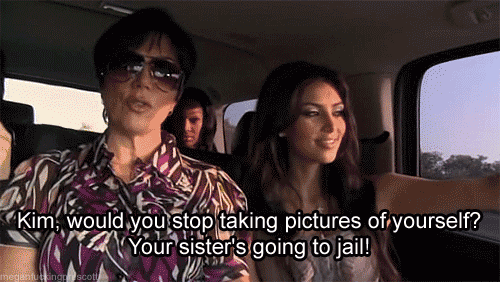 Kim takes selfies en route to jail.